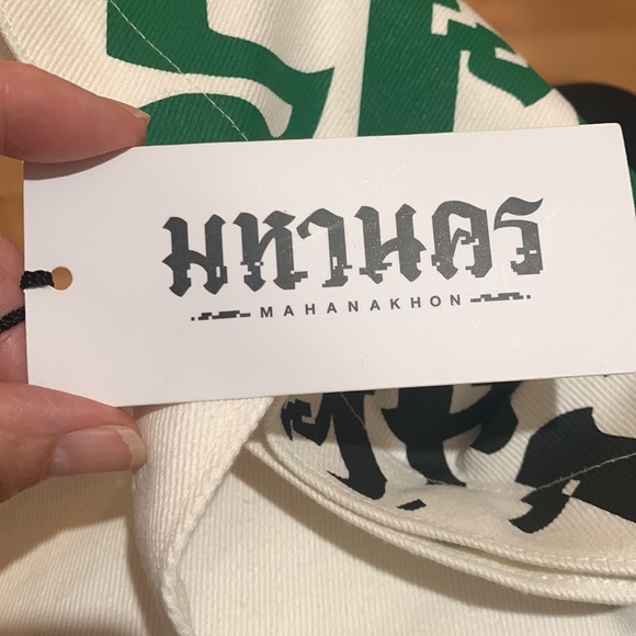 Mahanakhon Tote Bag with green and black font on cream canvas. Pushbutton close - Picture 6 of 6